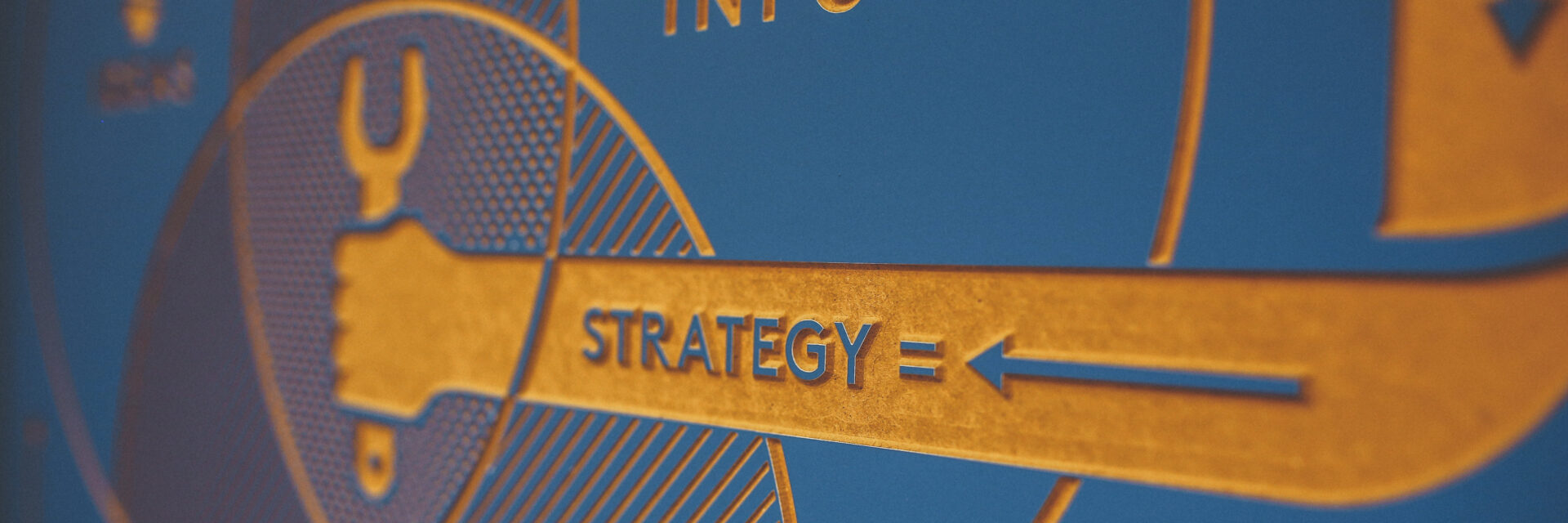 Graphic of arm holding a wrench with the words Strategy = arrow on the arm.