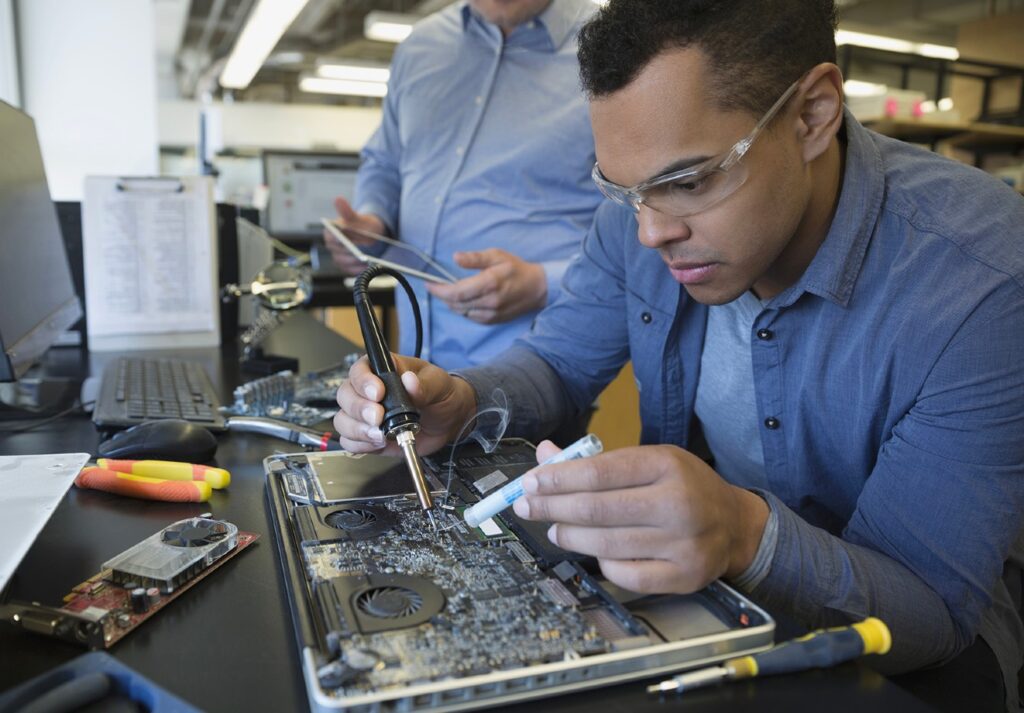 Male student working on a circuit board