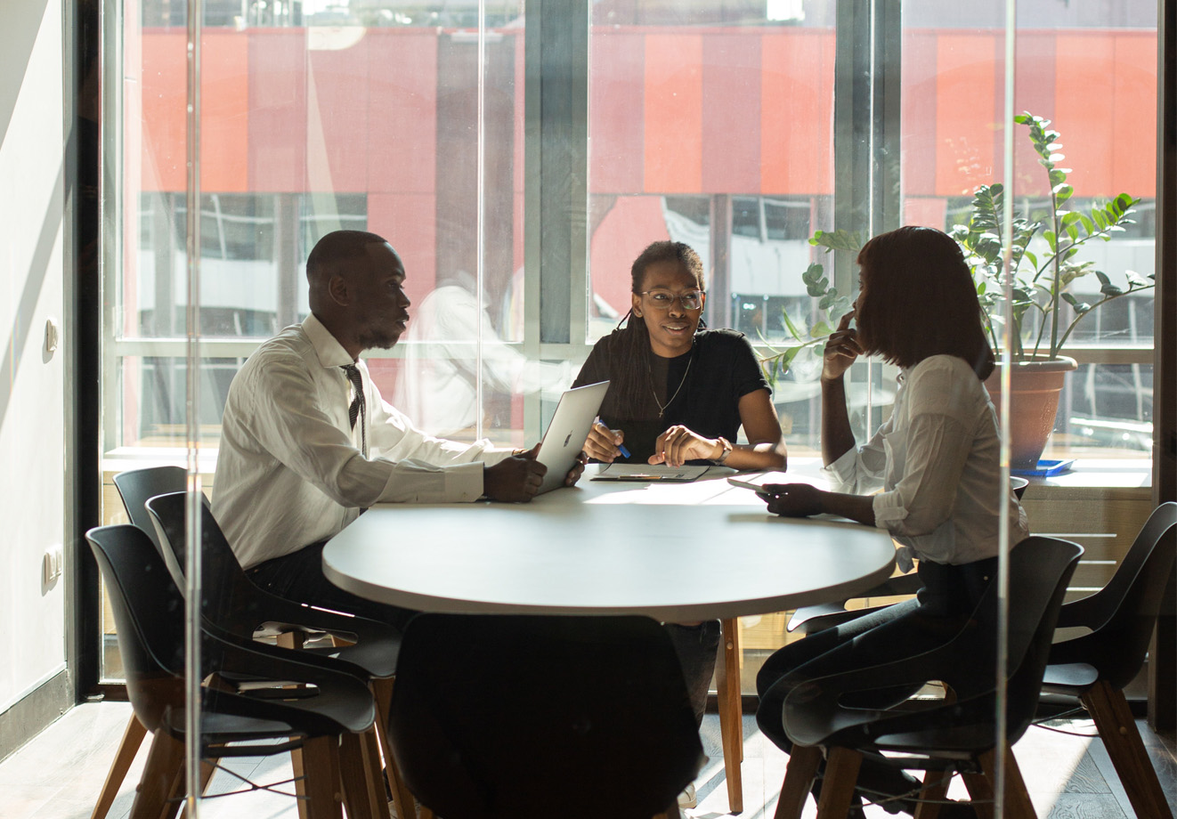 three employees sitting at a table