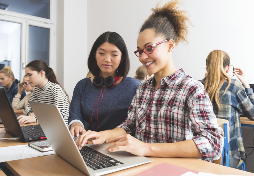 female students on laptop UNIT