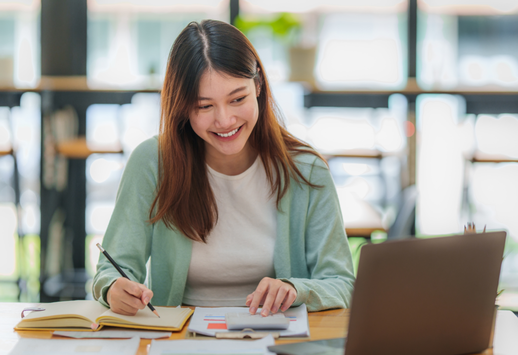 Woman working at desk with laptop