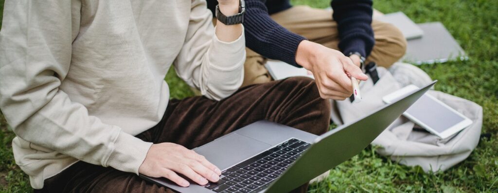 Two people discuss with computer