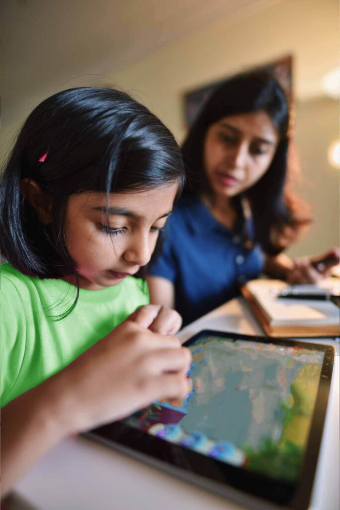 a child and mother learning through a tablet with brightspace