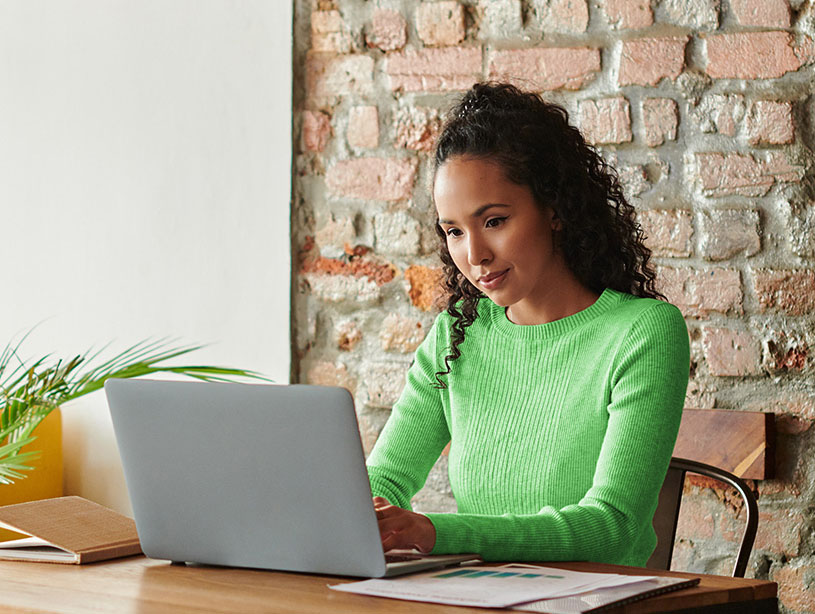 Woman working on laptop at a table