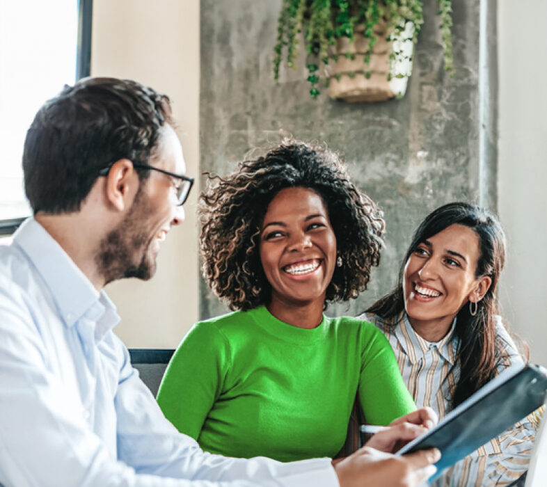 Three workers collaborating at desk
